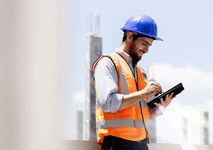 man in highvis reading tablet