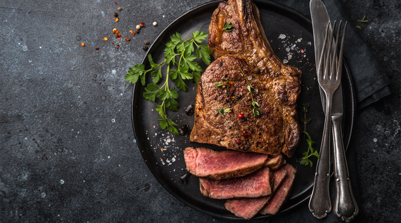 High-end luxury steak dinner on a granite surface to support Shawmut Design and Construction article