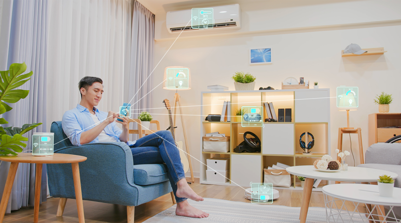 Man sat in a home filled with technology to support smart homes article